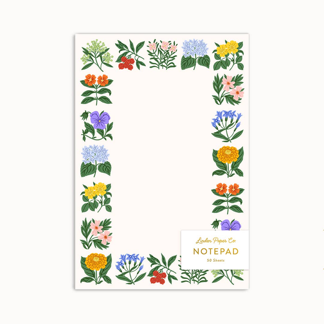 Linden Paper Co. Folk Floral Notepad with a colourful botanical border of illustrated wildflowers surrounding 50 unlined tear-out sheets — a cheerful desk stationery gift made in Canada.