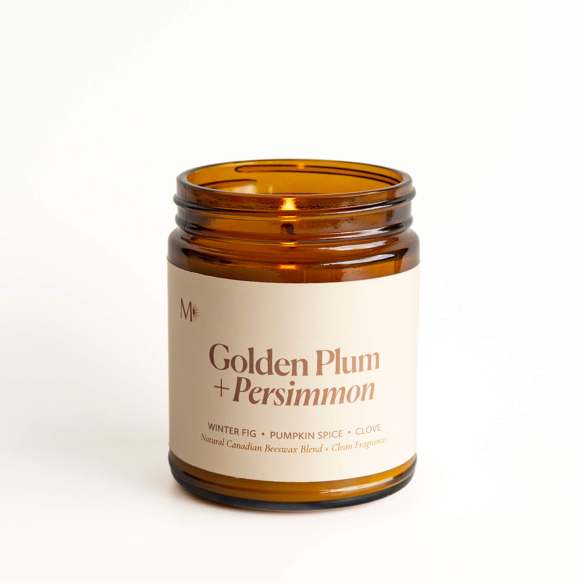 Golden Plum + Persimmon candle by Misiyo Candle Co, made with beeswax and coconut wax. Candle lit with a white background.