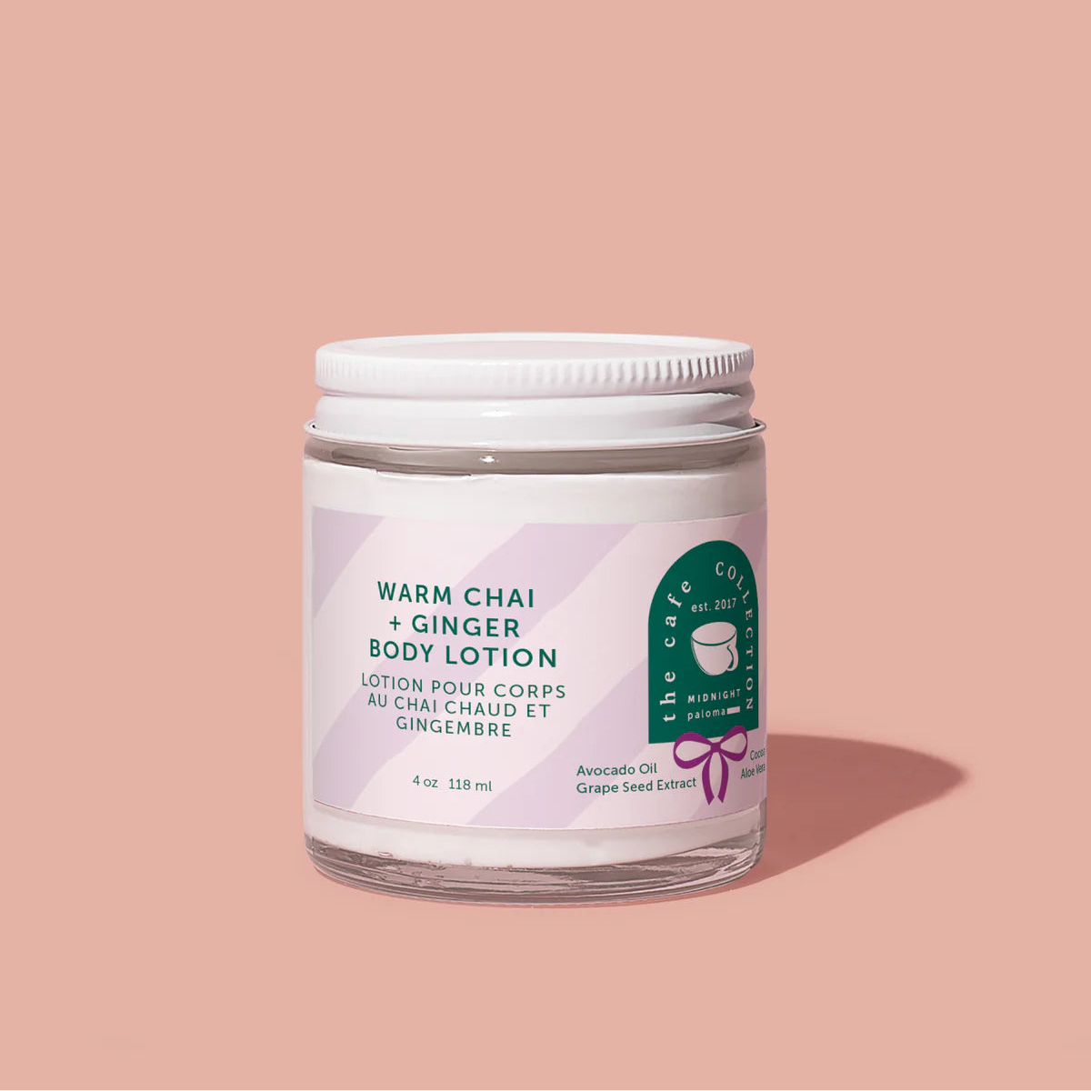 Body lotion jar labeled 'Warm Chai + Ginger' on a beige background