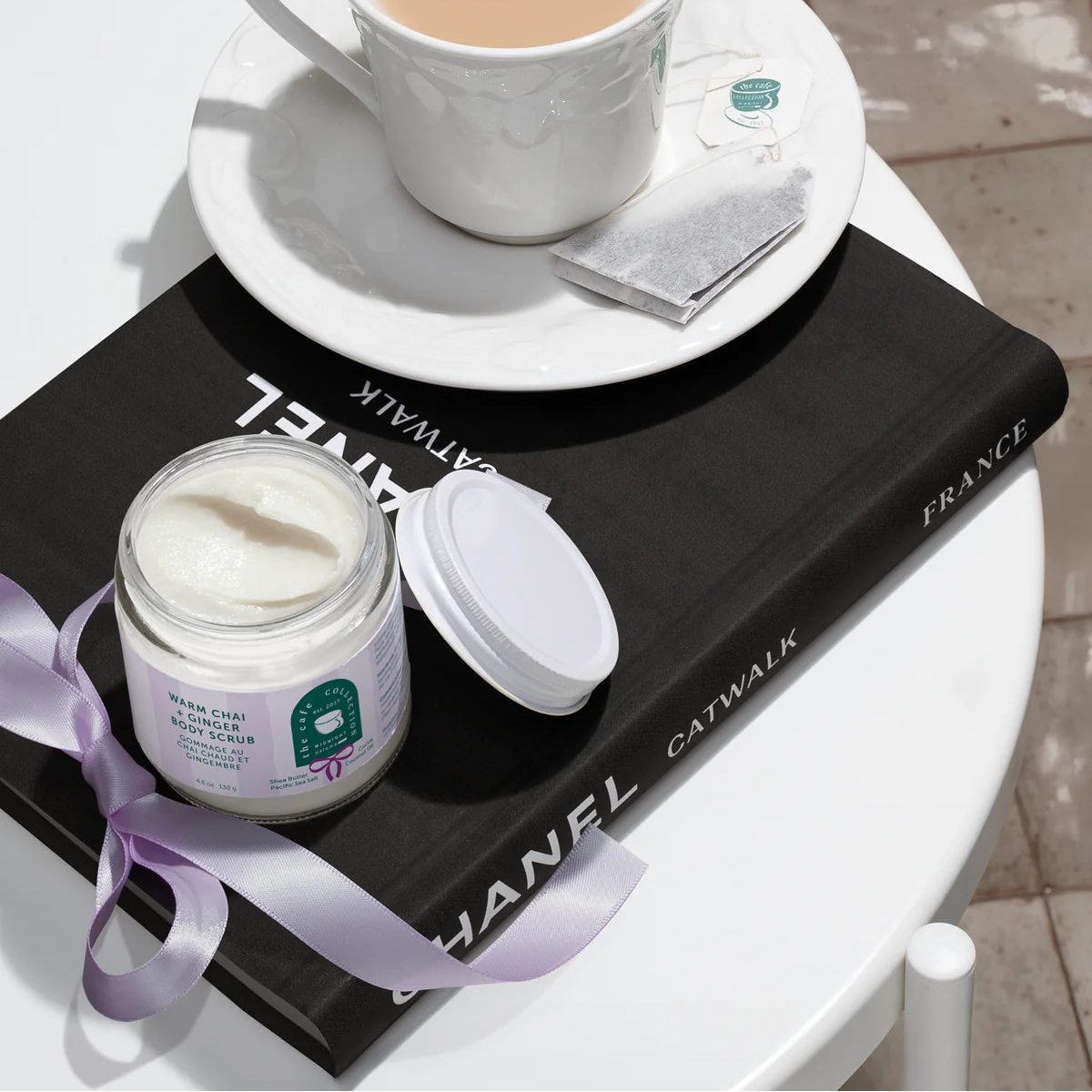 Jar of cream with a cup of tea on a Chanel magazine