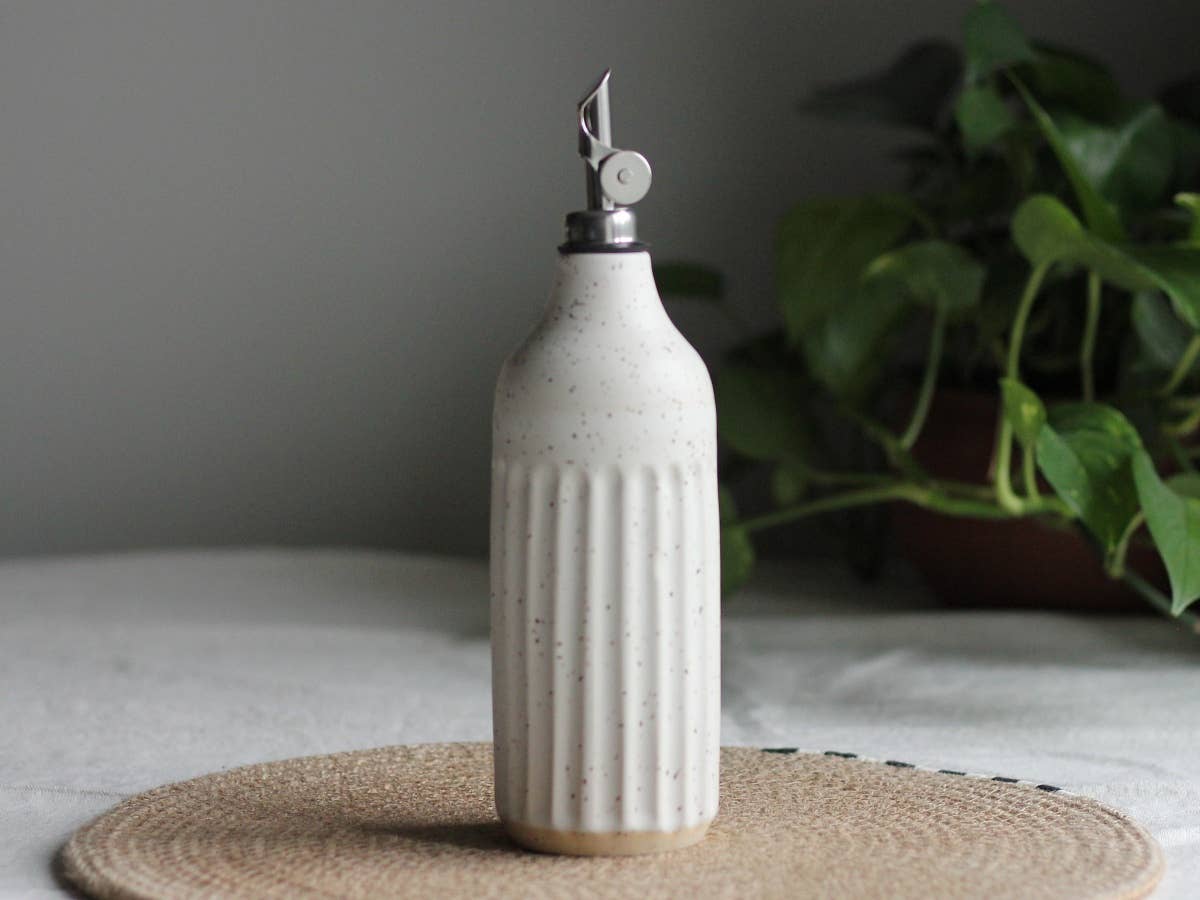 Calgary Clay Co. fluted ceramic oil cruet bottle in speckled white glaze. Handmade in Canada.