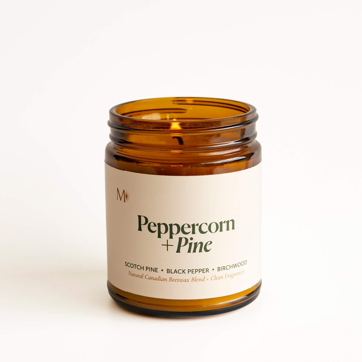 Misiyo Peppercorn + Pine fall candle — amber glass jar with cream label, scotch pine, black pepper & birchwood, natural beeswax blend, made in Canada