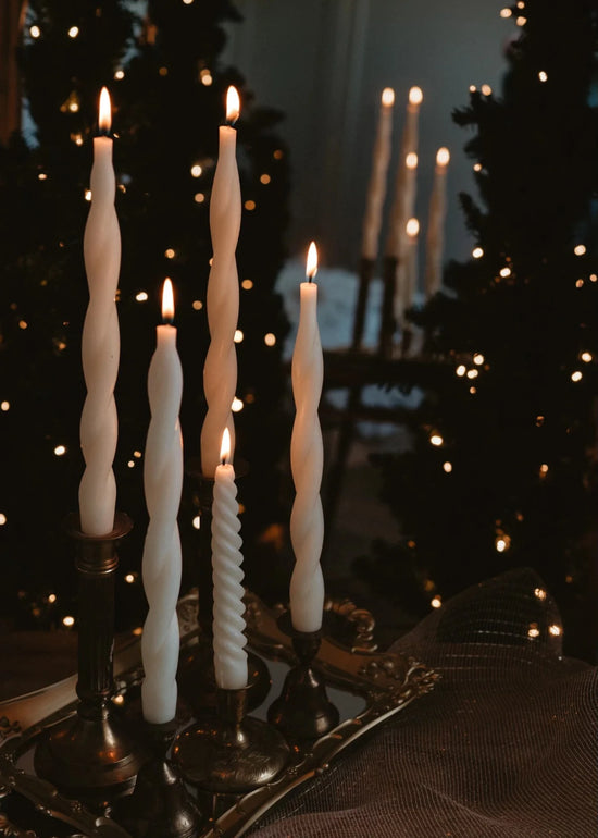 spiral beeswax taper candles burning with twinkle lights